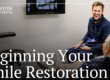 Doctor smiling at patient in chair