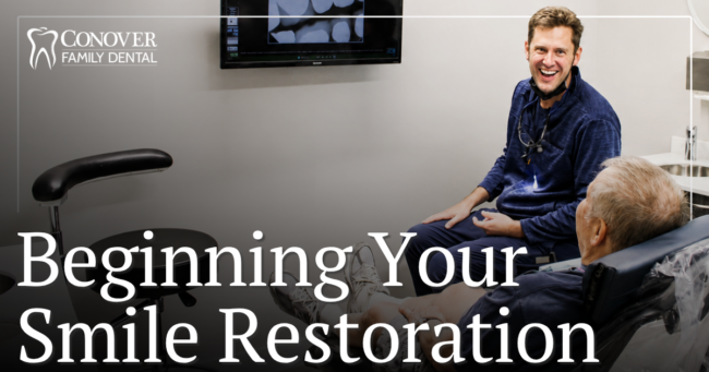 Beginning Your Smile Restoration Doctor smiling at patient in chair