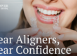 female patient holding clear aligners