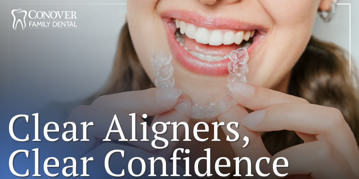 female patient holding clear aligners