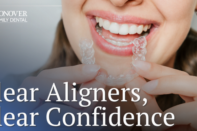 female patient holding clear aligners